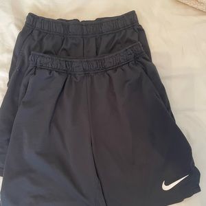 two pairs of black nike men’s medium shorts